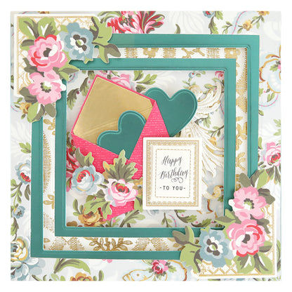 Birthday card featuring layered frames created with Concentric Square Dies, embellished with pink and green flowers, gold accents, a "Happy Birthday to You" card, and paired with a pink envelope decorated with teal hearts.