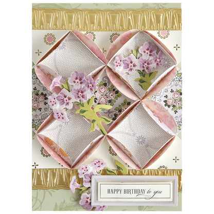 A decorative birthday card made with Turned Edge Dies, featuring layered floral designs, diamond-shaped paper folds, and a "Happy Birthday to you" message at the bottom.