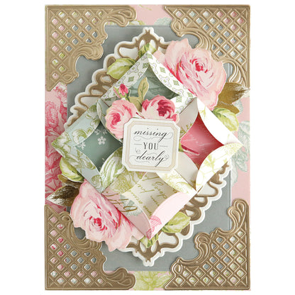 A floral greeting card made with Turned Edge Dies features pink roses, gold accents, an envelope with "missing you dearly" at the center, and elegant dimensional details for a refined finish.