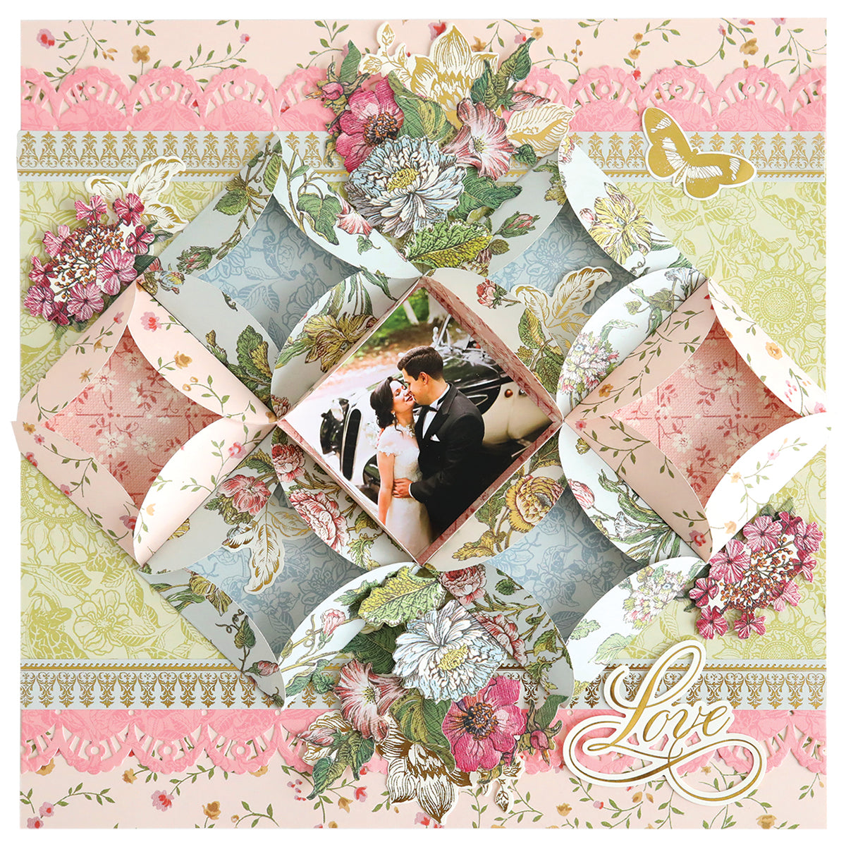 A scrapbook page showcases a bride and groom photo, with folded floral papers, lace accents made using Turned Edge Dies, and a "Love" embellishment in one corner.