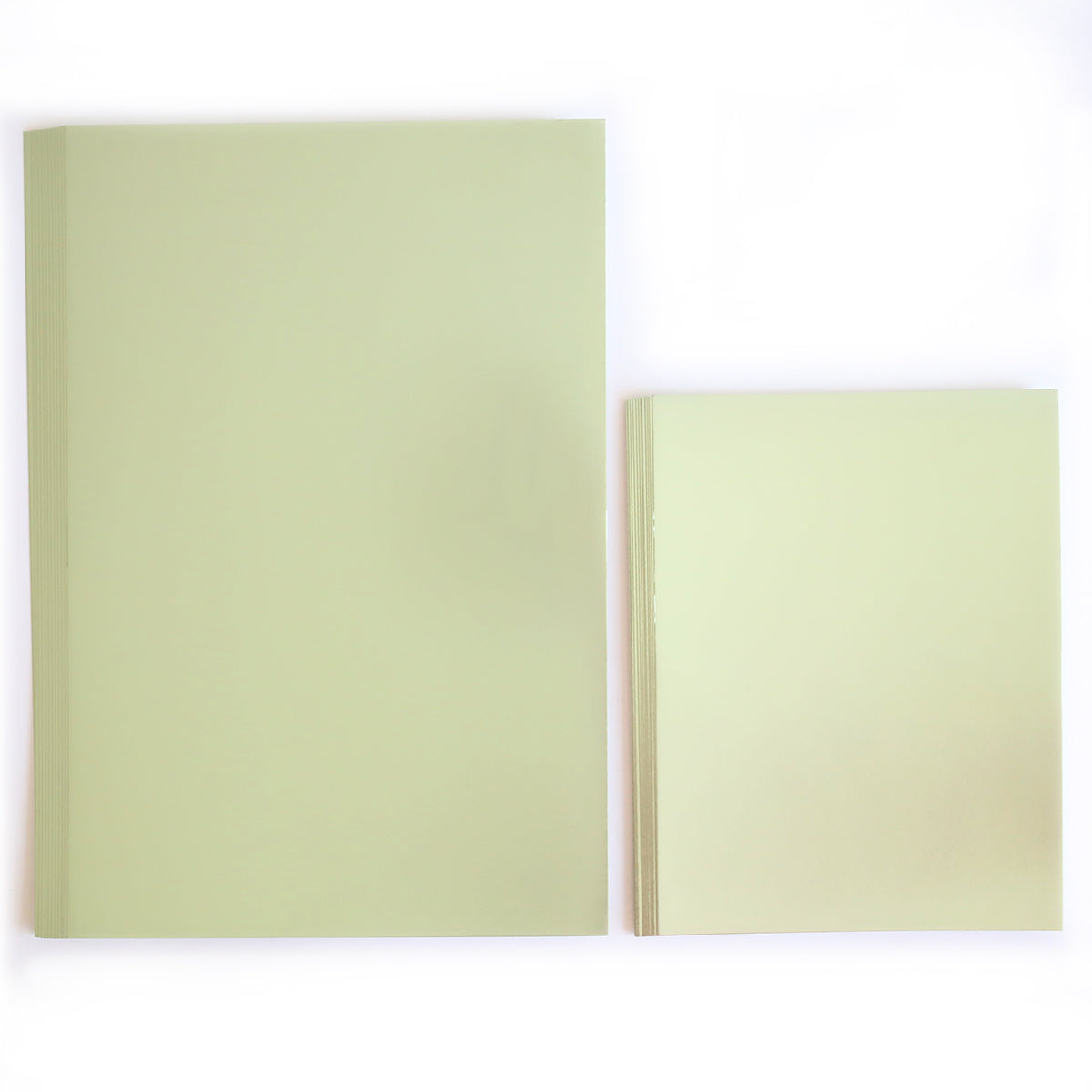 Two stacks of Luxury Rose Collection Green Matte Foil Cardstock, in large and small sizes, are arranged side by side on a white background—ideal for luxury card making projects.