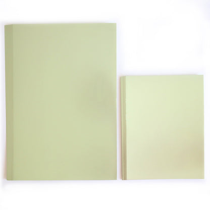 Two stacks of Luxury Rose Collection Green Matte Foil Cardstock, in large and small sizes, are arranged side by side on a white background—ideal for luxury card making projects.