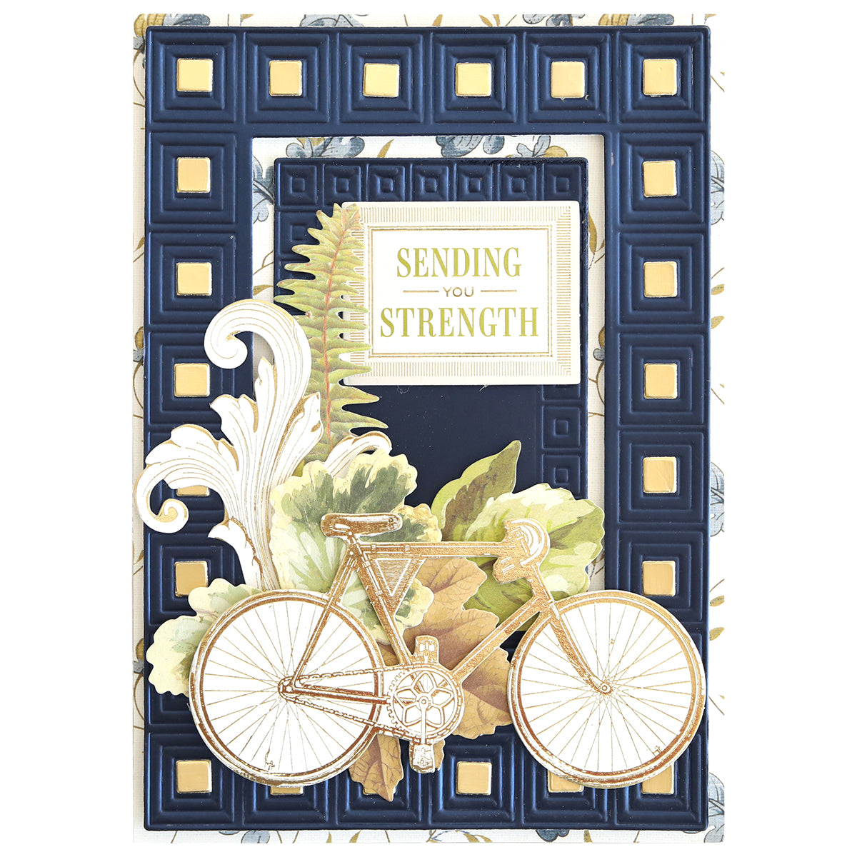 Greeting card from the Celebration Foil Cardstock Collection, adorned with a gold-trimmed bicycle, leaves, and fern, featuring a raised blue and gold border on navy matte foil cardstock and the message “Sending You Strength” in the center—an ideal addition to thoughtful paper crafts.