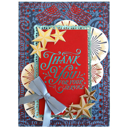 A decorative card with gold stars, a blue bow, and "Thank You For Your Service" on a red background with American flag and fireworks—perfect for July 4th crafts or pairing with Gilded Patriotic Frame and Sentiment Hot Foil Plates.