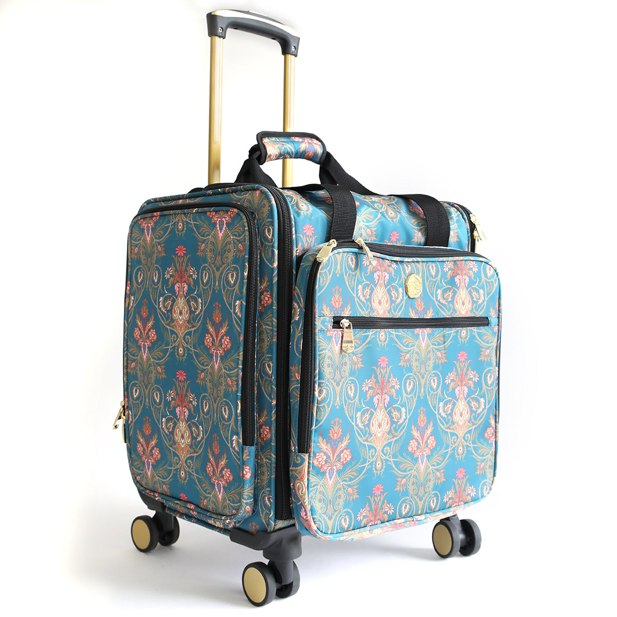 The Jasmine Rolling Craft Luggage features a blue floral pattern, gold handles, and four wheels. Shown upright on a white background, this stylish and functional organizer is perfect for your travels.