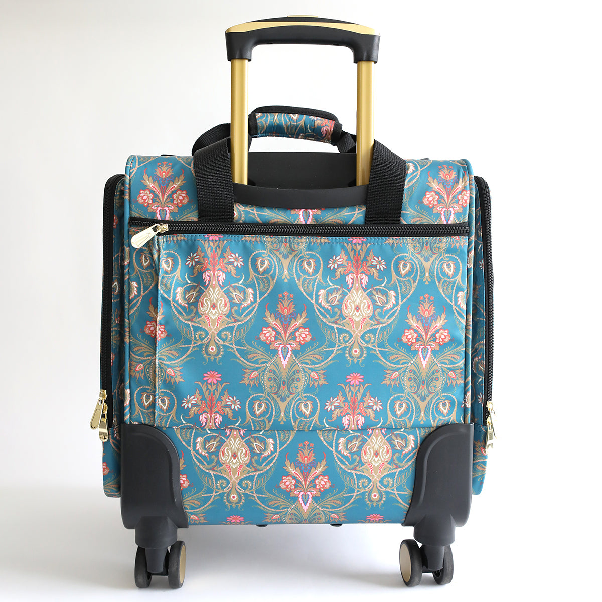 The Jasmine Rolling Craft Luggage, featuring a teal floral pattern, black handles, gold telescopic handle, and four wheels, is photographed against a white background.