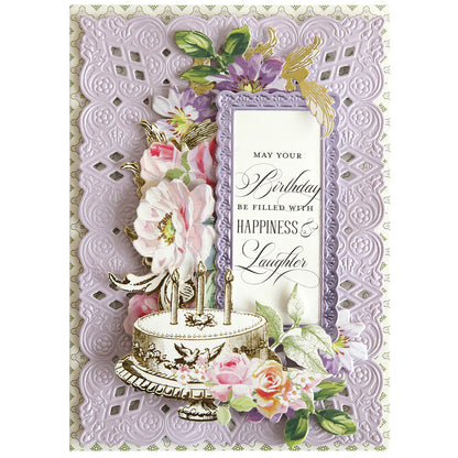 Birthday card featuring a decorative cake, flowers, gold accents, and a purple lace-like background crafted with Dream 3D Frame and Border Dies. The message: “May your birthday be filled with happiness & laughter.”.