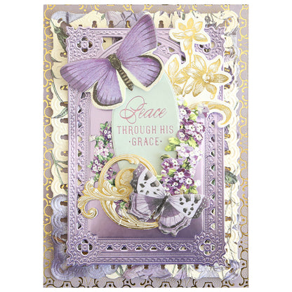 Decorative greeting card adorned with purple butterflies, gold accents, and delicate floral details, featuring the sentiment “Peace through His grace” at the center. Perfect for handmade card enthusiasts, this design highlights the Gilded Small Blessings Sentiment Foil Plates, adding an elegant and sophisticated touch with hot foil embellishments.