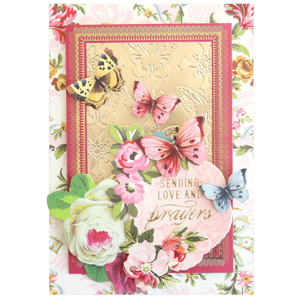 Greeting card featuring an embossed gold panel crafted with the Gilded Small Sentiments Foil Plates Bundle, adorned with vibrant butterflies and floral accents. The card displays the message "Sending love and prayers." Set against a floral background in shades of pink, gold, and green—ideal for handmade crafting enthusiasts.