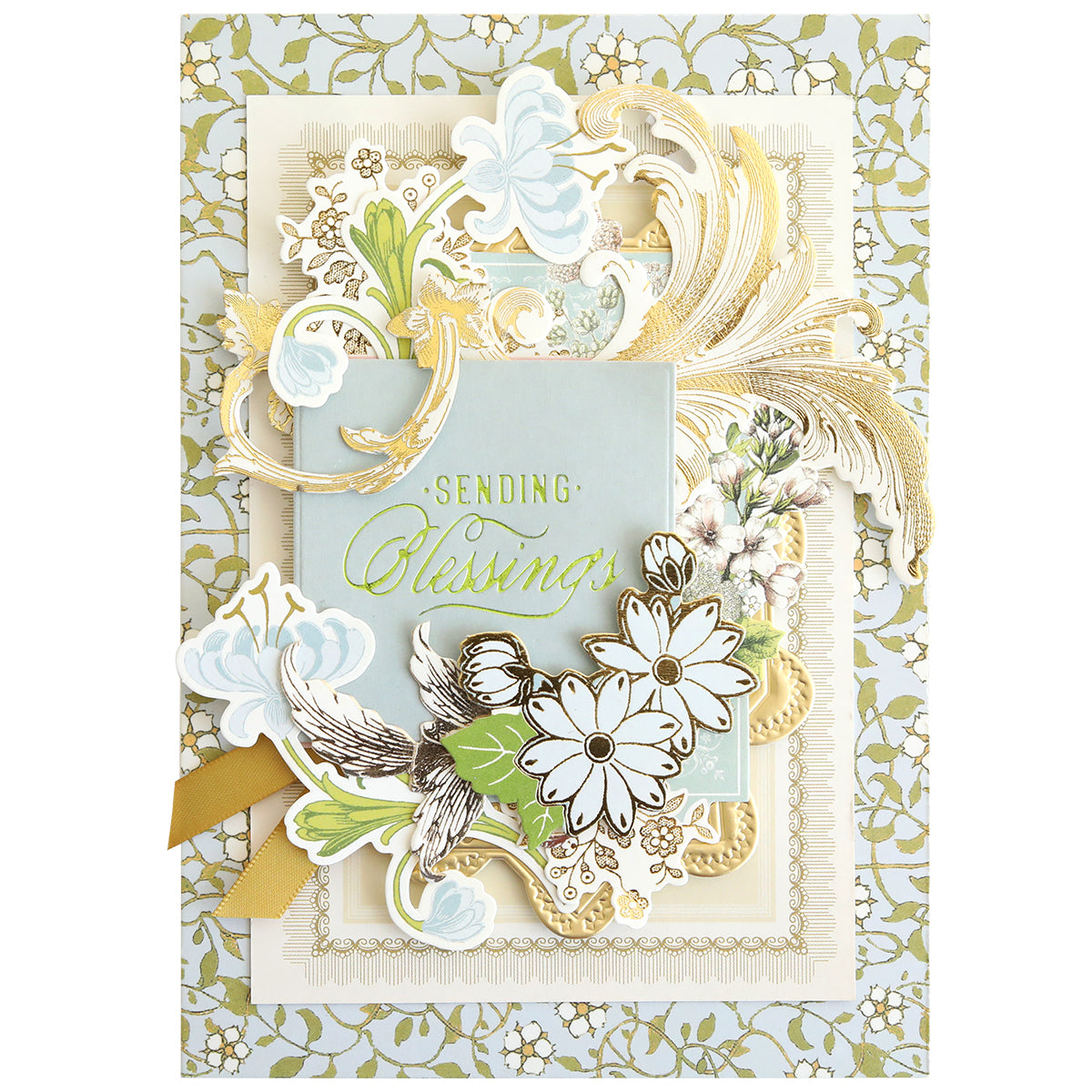 Featuring the "Sending Blessings" message, this greeting card is adorned with layered gold, white, and pastel floral motifs set against an ornate background of lace-inspired green and white patterns. Perfect for handmade card enthusiasts, it showcases the artistry of the Gilded Small Blessings Sentiment Foil Plates and adds a heartfelt touch to any creation.