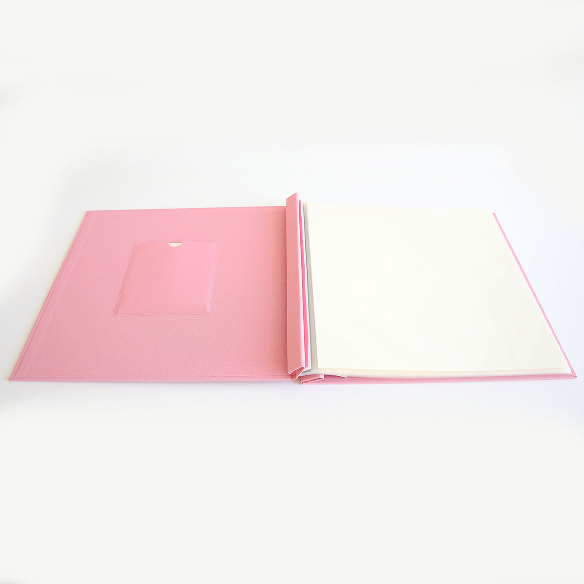 The Rose Pink Post Bound Scrapbook Album features a blank white page and a small inside cover pocket, ideal for memory keeping, all set against a plain white background.