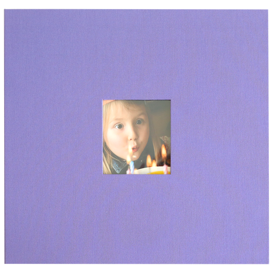 A young child blows out candles on a birthday cake in a small square photo, centered on a plain lavender background—ideal for displaying in your Charlie Purple Post Bound Scrapbook Album.