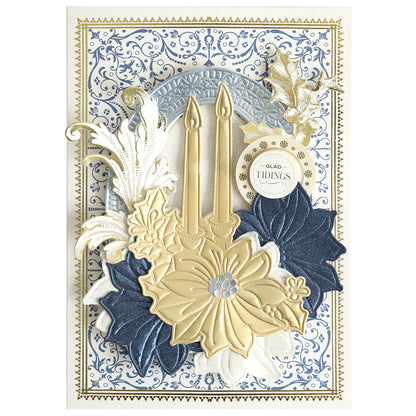 Create stunning layered Christmas cards with the 3D Holiday Candlelight Scene Dies, featuring two gold candles, gold and blue flowers, ornate flourishes, and a "Glad Tidings" tag set against an intricate blue and white patterned background—perfect for paper crafting enthusiasts who love decorative designs.