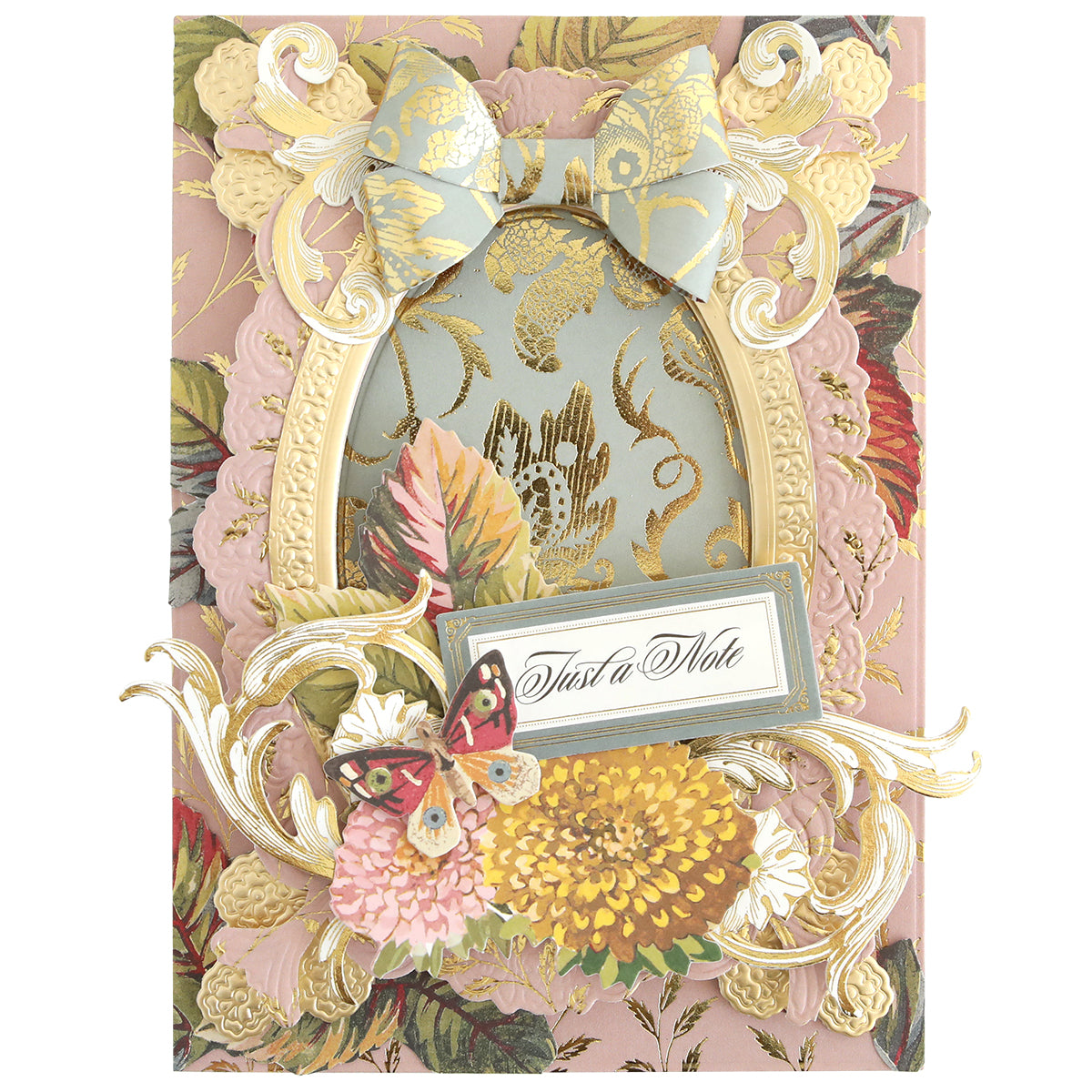 Elevate your fall card making or autumn scrapbooking with Sienna Cardstock and Embellishments, featuring a decorative floral greeting card adorned with ornate designs, a blue patterned bow, gold frame, butterfly, and flowers. At the center is a “Just a Note” label for that special touch. Crafted on premium cardstock to ensure lasting beauty.