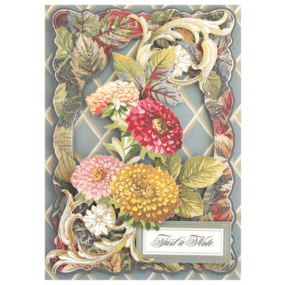 Greeting card crafted with Sienna Cardstock and Embellishments, featuring an ornate gold and floral border adorned with colorful fall-inspired flowers and leaves. Perfect for autumn-themed scrapbook projects, this design includes a label in the bottom right corner that reads “Just a Note.”.