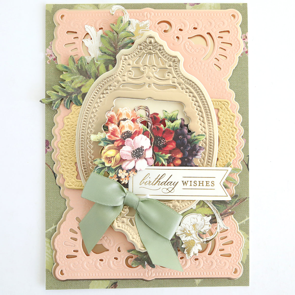 Handcrafted greeting card featuring ornate layered frames, vibrant flowers, and a green ribbon bow, accented with Fall Ephemera Embellishments and a “birthday wishes” banner on a soft pastel background.