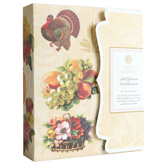 Housed in a box adorned with charming illustrations of a turkey, fruit, and flowers and labeled “Anna Griffin Fall Ephemera Embellishments,” this set is perfect for your seasonal paper crafting or for designing stunning Thanksgiving cards. Each box includes exquisite embellishments to elevate all your autumn-themed projects.
