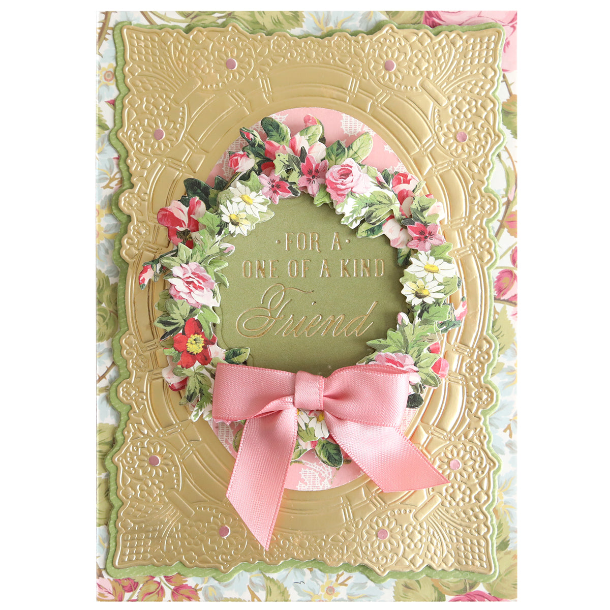 Greeting card featuring a floral wreath and pink bow, crafted with the Gilded Friendship Sentiment Foil Plates to create a gold embossed frame. The center text reads, “For a one of a kind friend.”.
