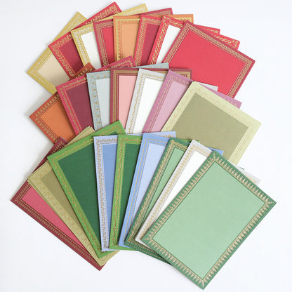 The Holiday Photo Mat and Card Layer Bundle features an assortment of decorative blank certificates in red, green, blue, pink, and beige, each bordered with intricate gold patterns and spread out on a white surface—ideal for use as photo mat card layers or in creative card making projects.