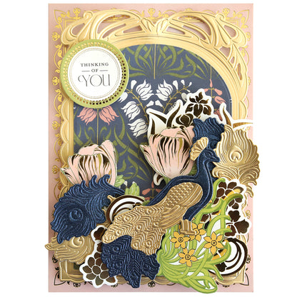 Handmade “Thinking of You” greeting card featuring layered paper peacocks crafted with the Peacock Scene 3D Dies, gold art nouveau frame, navy, pink, and gold tulips and floral embellishments.