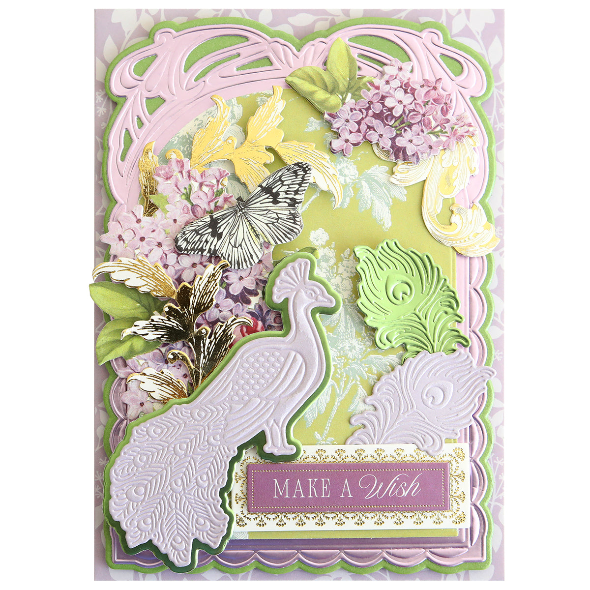 Beautifully crafted with the Peacock Scene 3D Dies, this greeting card showcases layered designs featuring a dimensional peacock, butterfly accents, gold birds, lilac flowers, and ornate patterns—all assembled using embossing dies and a layered die set—finished with a “MAKE A WISH” label at the bottom.