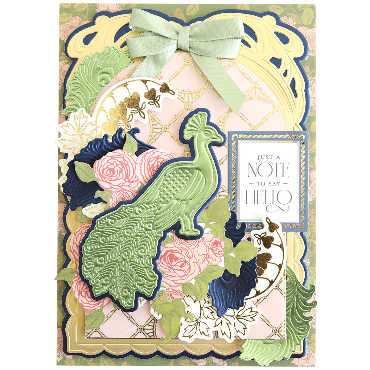 The Peacock Scene 3D Dies greeting card showcases a dimensional peacock design with pastel flowers, gold accents, and a “Just a note to say hello” tag, all elegantly finished with a green ribbon bow.
