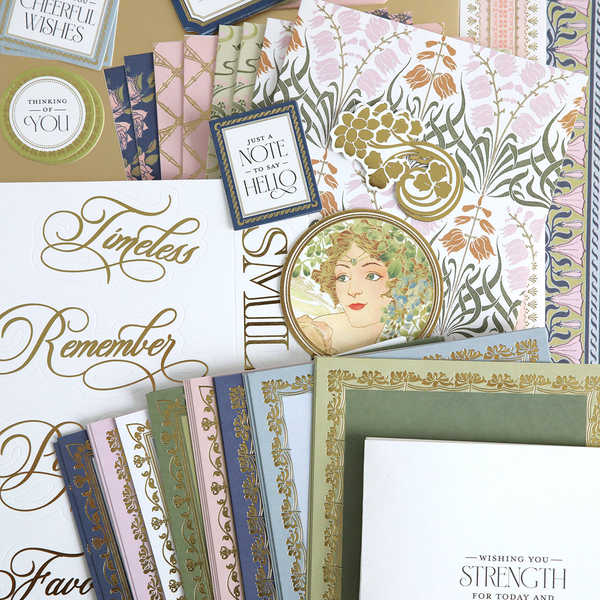 Dahlia Ultimate Papercrafting Collection featuring assorted decorative stationery items adorned with floral motifs, gold accents, ornate borders, and elegant calligraphy—including greeting cards, scrapbook pages, handmade cards, and envelopes—artfully arranged in an overlapping pattern.