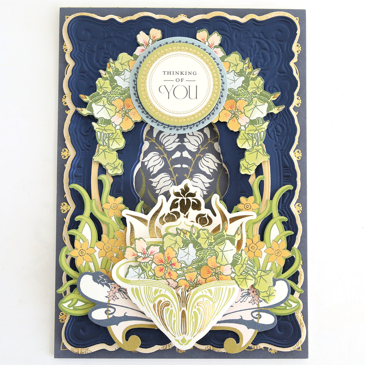 Handmade card with layered blue and gold borders, intricate floral designs, and a circular “Thinking of You” message at the top center—a beautiful addition to your scrapbook pages or any handmade cards collection crafted using your Dahlia Ultimate Papercrafting Collection.
