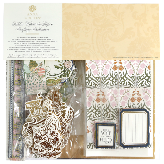 The Dahlia Ultimate Papercrafting Collection kit features patterned papers, ornate die-cuts, tags, and embellishments in clear packaging—perfect for creating beautiful scrapbook pages and handmade cards.