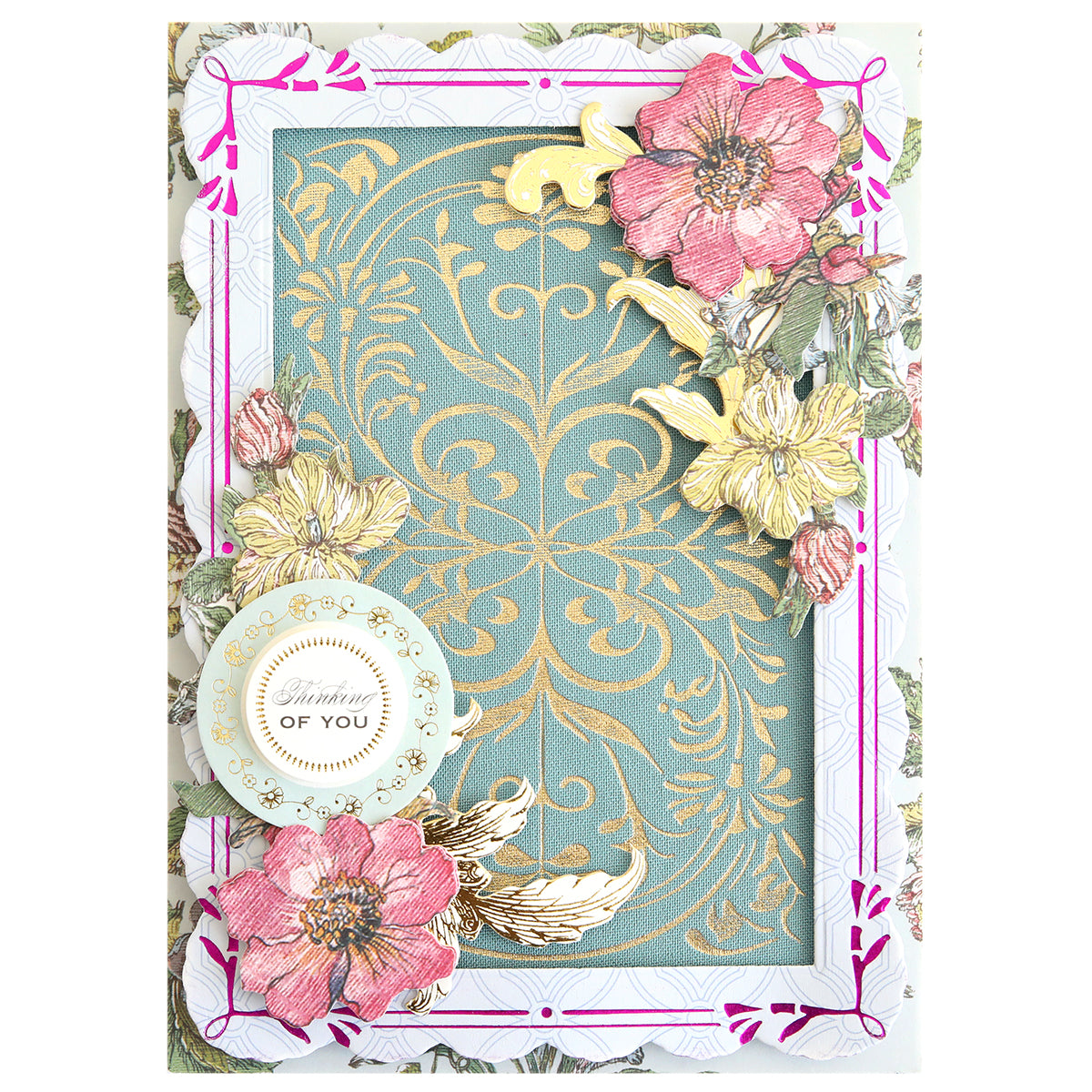 Decorative greeting card featuring gold floral patterns, pink and yellow flowers, a gold bird, and a round tag that reads “Thinking of You” on a blue and gold ornate background. Perfect for handmade card enthusiasts, this design showcases beautiful detailing created with the Gilded Art Nouveau Border & Pattern Hot Foil Plate for an exquisite, luxurious finish.