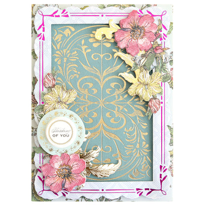 Decorative greeting card featuring gold floral patterns, pink and yellow flowers, a gold bird, and a round tag that reads “Thinking of You” on a blue and gold ornate background. Perfect for handmade card enthusiasts, this design showcases beautiful detailing created with the Gilded Art Nouveau Border & Pattern Hot Foil Plate for an exquisite, luxurious finish.