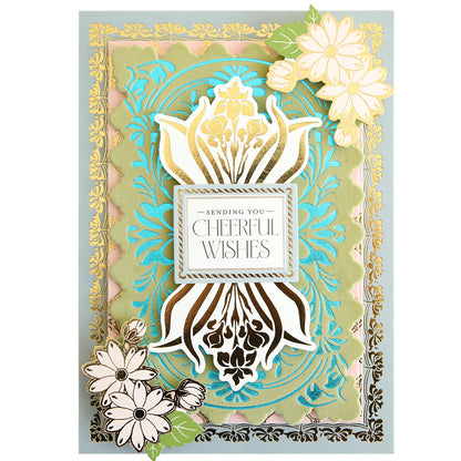 A decorative greeting card showcasing gold, teal, and pink floral designs with the message “Sending You Cheerful Wishes” in the center and elegant clusters of flowers in two corners—crafted using papercrafting techniques and the Gilded Art Nouveau Border & Pattern Hot Foil Plate.