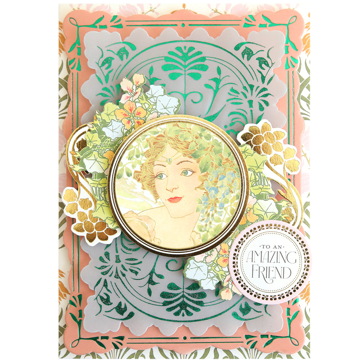 Greeting card featuring an ornate, layered floral design created with handmade card techniques, showcasing a vintage-style portrait of a woman at the center beautifully accentuated by Gilded Art Nouveau Border & Pattern Hot Foil Plate details from Anna Griffin, and finished with a round label that reads “To an Amazing Friend” in decorative text.