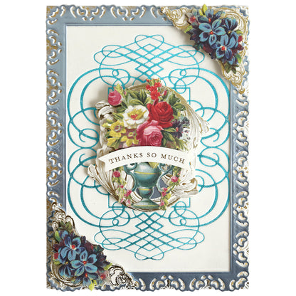 Show your appreciation with this decorative handmade card, crafted using the Calligraphy Frame Gilded Hot Foil Plate. Featuring an ornate blue border, elegant gold foil plate accents in the corners, and a central floral bouquet with the words “THANKS SO MUCH,” it’s perfect for enhancing scrapbook layouts or presenting to someone special.