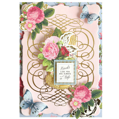 Greeting card featuring designs created with the Calligraphy Frame Gilded Hot Foil Plate, adorned with gold foil accents, pink roses, and blue butterflies. Inspired by elegant scrapbook pages, the center showcases a delicate frame bearing the sentiment, “Friends like you are always in style.”.