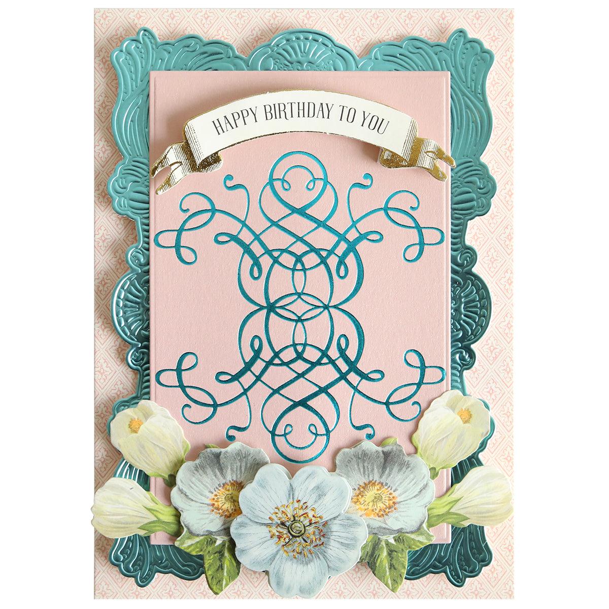 A birthday card featuring ornate blue and pink designs, accented with white flowers along the bottom and a “Happy Birthday To You” banner at the top—perfect for paper crafting enthusiasts. The elegant finish of this card is inspired by Flourish and Vine Gilded Hot Foil Plates, adding refined Empress Gild detailing reminiscent of luxurious hot foiling.