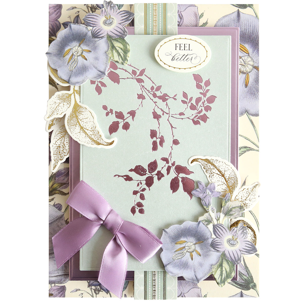 Greeting card with a “Feel better” message, beautifully enhanced using Flourish and Vine Gilded Hot Foil Plates for added shine, decorated with purple flowers, a lavender bow, and floral accents on a patterned background—perfect for anyone who loves paper crafting.