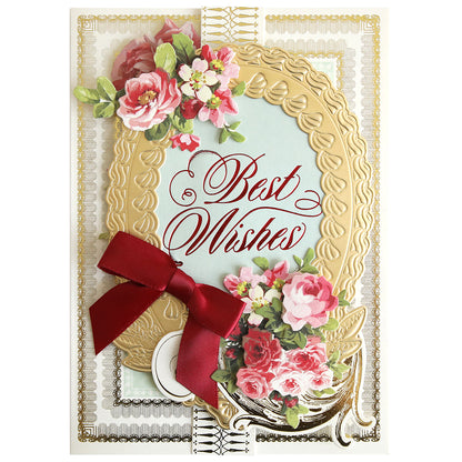 A handmade greeting card featuring a gold oval frame, pink roses, a red ribbon, and “Best Wishes” in red calligraphy created with Thoughtful Calligraphy Gilded Hot Foil Plates.