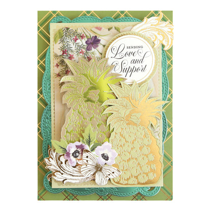 Handmade greeting card created with the Rose and Pineapple Gilded Hot Foil Plates, featuring elegant gold and green pineapples, white and purple flowers, and a circular tag that reads “Sending Love and Support” on beautifully layered, ornate backgrounds—a perfect piece for your handmade cards collection or to spark inspiration for your next papercrafting project.