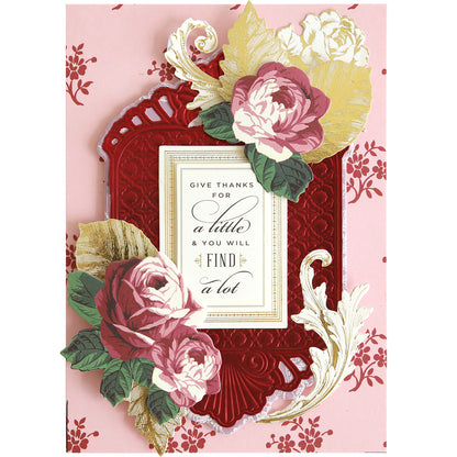 Handmade card crafted with Rectangle Pattern 3D Layer Dies, featuring an embossed red border, gold and white accents, pink and white roses, and the message: “Give thanks for a little & you will find a lot.” With a pink background and intricate red floral design made using the dies, this elegant piece is ideal for card making enthusiasts seeking to add dimension and sophistication.
