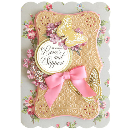 Handcrafted greeting card created using the Rectangle Pattern 3D Layer Dies, highlighted with an elegant pink bow, gold and pink butterflies, and intricate floral embellishments. The card features the heartfelt message “Sending Love and Support” in graceful script. An ideal choice for card making enthusiasts who value unique designs and meaningful sentiments.