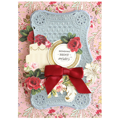 Handcrafted card featuring an embossed blue cover, red bow, roses, and gold accents with a “Sending Best Wishes” sentiment—beautifully displayed on a pink floral background and designed using Rectangle Pattern 3D Layer Dies.