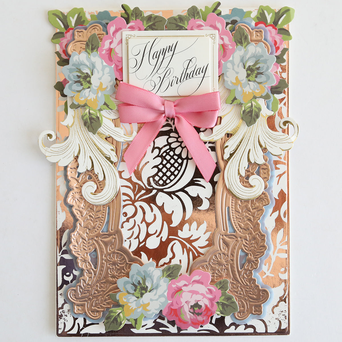 Create an elegant birthday card using the Gilded Solid Foil Plate 4x6 for gold accents, floral embellishments, and a pink ribbon with a “Happy Birthday” greeting centered on white cardstock—ideal for stylish card making.