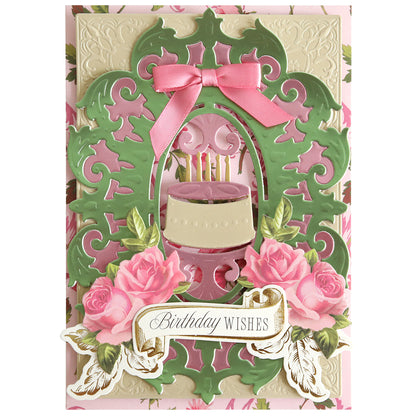 Ornate handmade birthday card featuring pink roses, a pink ribbon, a cake with candles, and a “Birthday Wishes” message on an elegant green and cream background. Perfect for use with the Cake and Suit Card Front Dies and your die cutting machine to add an extra-special touch.