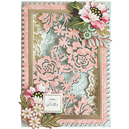 Handmade greeting card featuring pink and white layered floral cutouts created with the Bird and Floral Card Front Dies, highlighted with gold accents and a “Feel Better” sentiment in the bottom left corner.