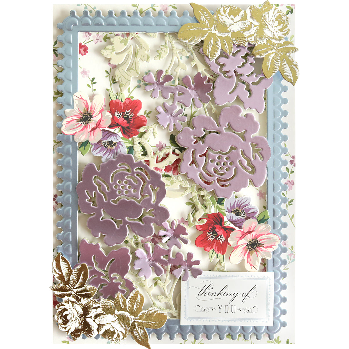 Greeting card showcasing layered purple, pink, and gold floral designs created with Bird and Floral Card Front Dies for an elegant touch. Accented with a blue decorative frame and a “thinking of you” sentiment in the bottom right corner, this card was expertly crafted using die-cutting machines.