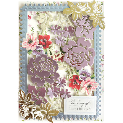 Greeting card showcasing layered purple, pink, and gold floral designs created with Bird and Floral Card Front Dies for an elegant touch. Accented with a blue decorative frame and a “thinking of you” sentiment in the bottom right corner, this card was expertly crafted using die-cutting machines.