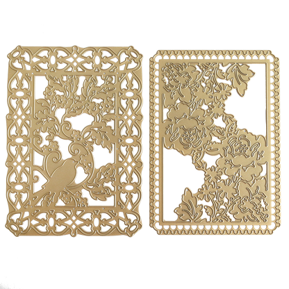 Showcasing the Bird and Floral Card Front Dies, this set includes two gold, intricately cut metal cards: one depicts a bird perched in a leafy tree, while the other features an elegant floral pattern with overlapping flowers and leaves—both exquisitely crafted for precise detail using these decorative cutting dies.