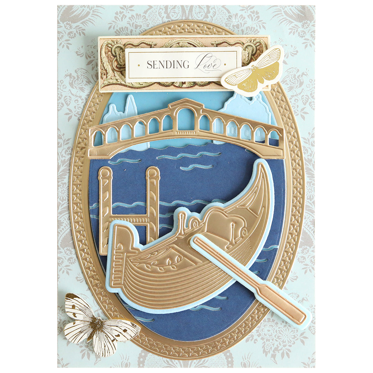 The Gondola 3D Scene Dies set features dimensional die cuts of a gondola gliding on water, a bridge, delicate butterflies, and the sentiment “Sending love” at the top—perfect for Venice-inspired paper crafting projects.