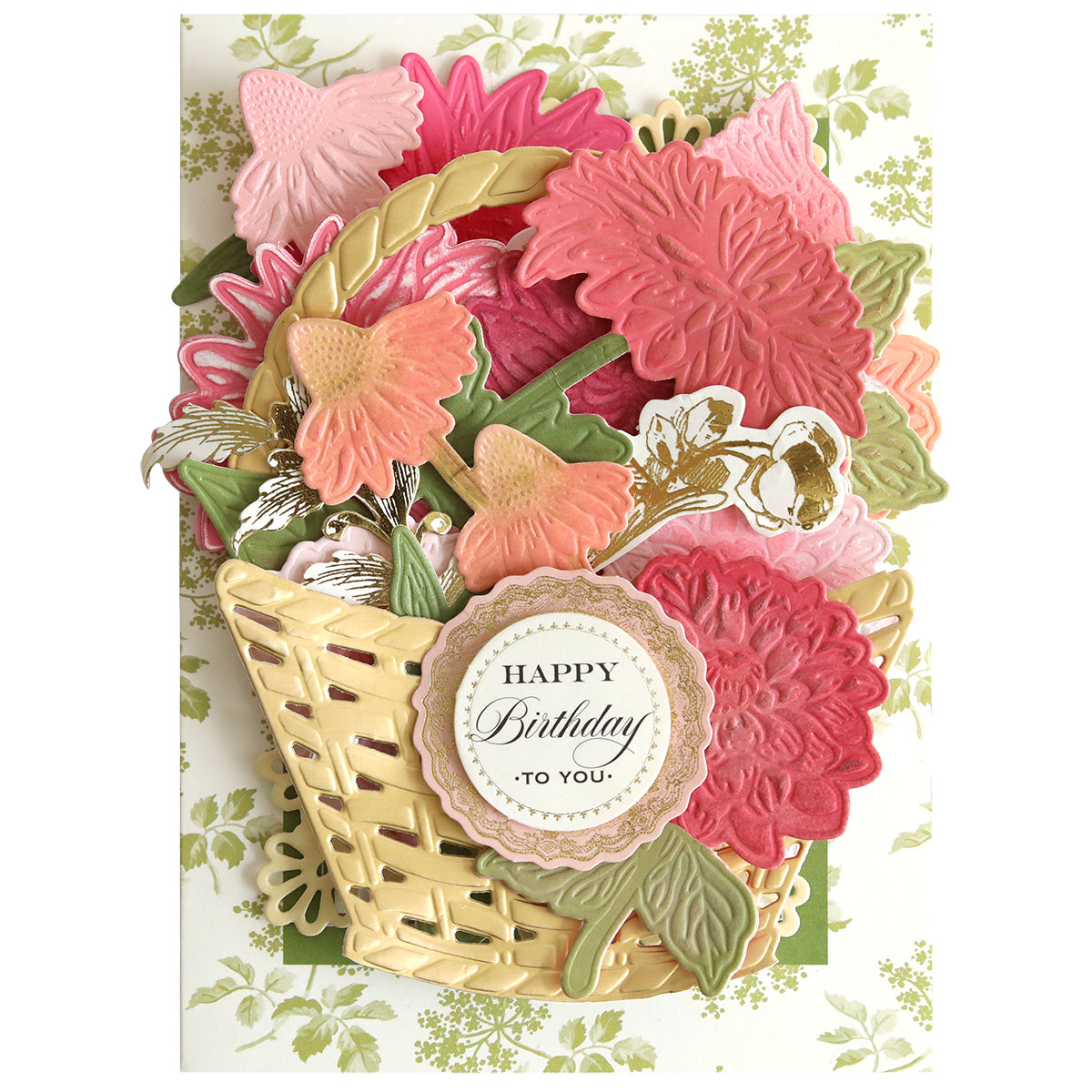 Greeting card created using the Dahlia, Mum, and Sunflower 3D Floral Dies, featuring a basket of pink and red flowers with lush green leaves and intricate botanical detailing. A round label reading “Happy Birthday to You” adorns the design, set against a vibrant green floral background—making it an ideal project for paper crafts enthusiasts.